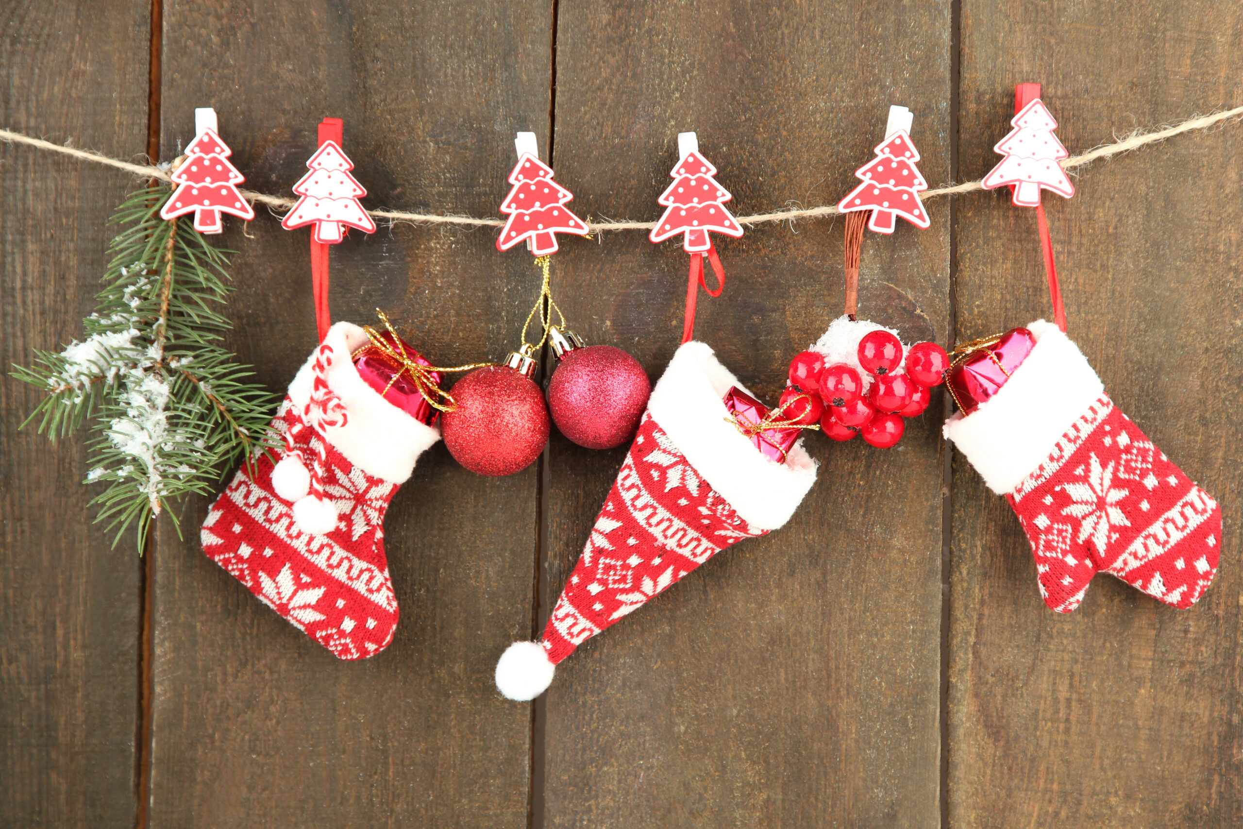 Christmas accessories hanging on  grey wooden wall